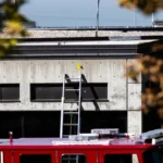 Evidence markers are placed on the roof and side of a building at Utah Valley University.